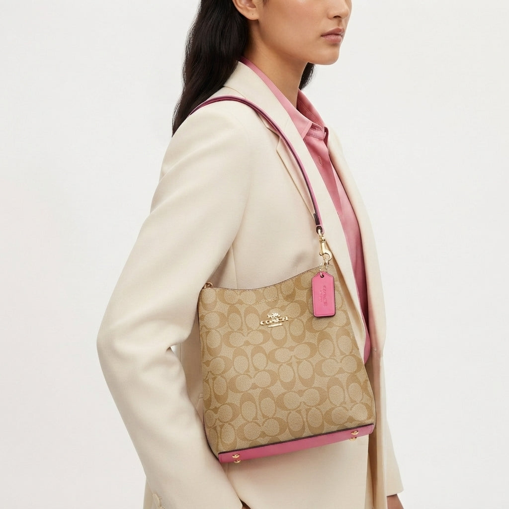 Coach Signature Canvas Bucket Bag with Vibrant Pink Accents