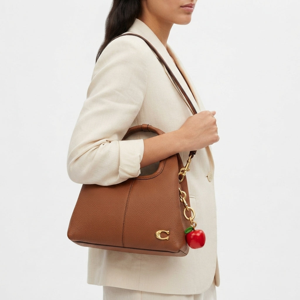 Coach Pebble Grain Leather Handbag with Playful Apple Charm