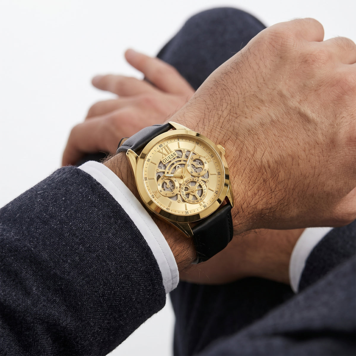 Guess Gold Tone Skeleton Dial Watch with Black Leather Strap
