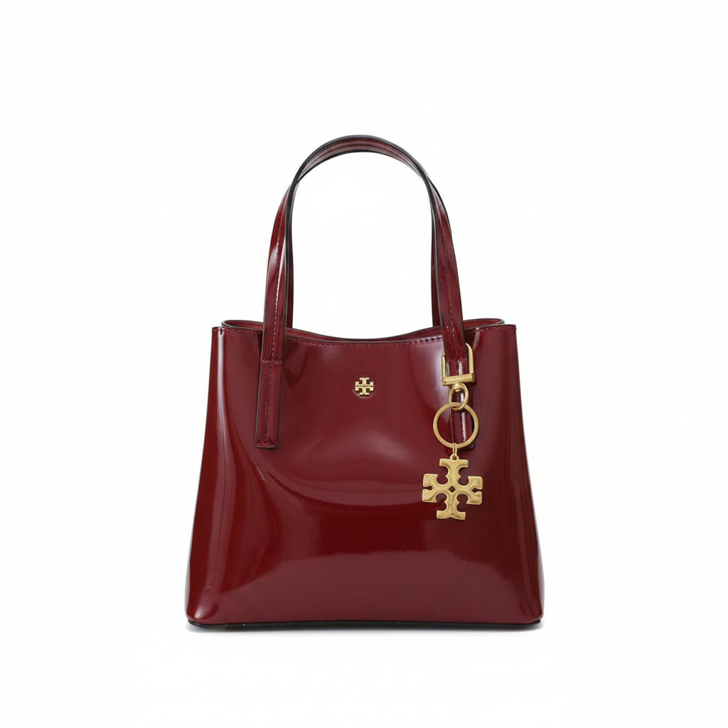 Tory Burch Patent Leather Handbag with Gold Tone Logo Charm