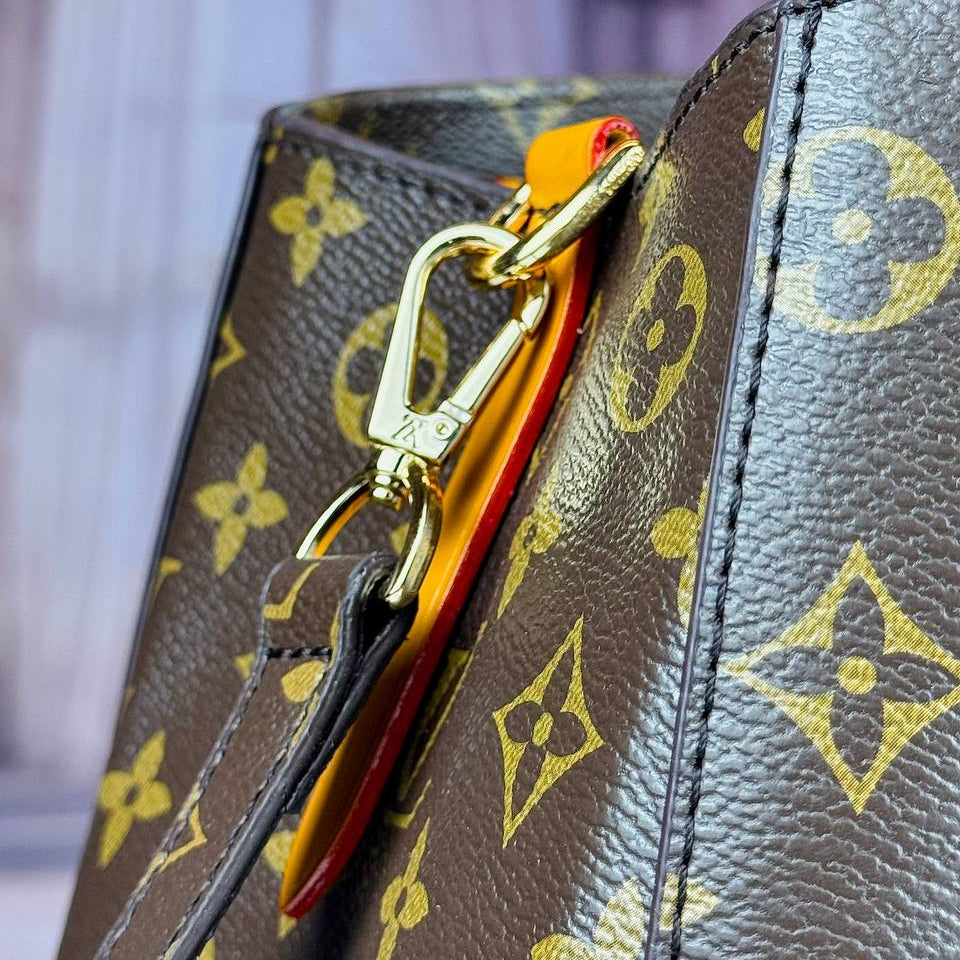 Louis Vuitton Monogram Handbag with Vibrant Orange Accents