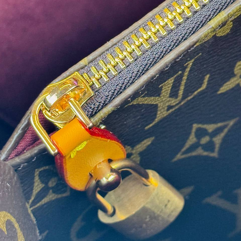 Louis Vuitton Monogram Handbag with Vibrant Orange Accents