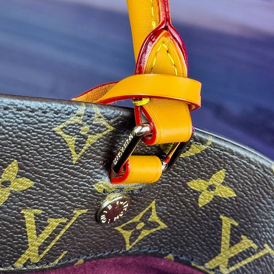 Louis Vuitton Monogram Handbag with Vibrant Orange Accents