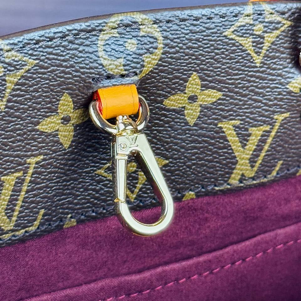 Louis Vuitton Monogram Handbag with Vibrant Orange Accents