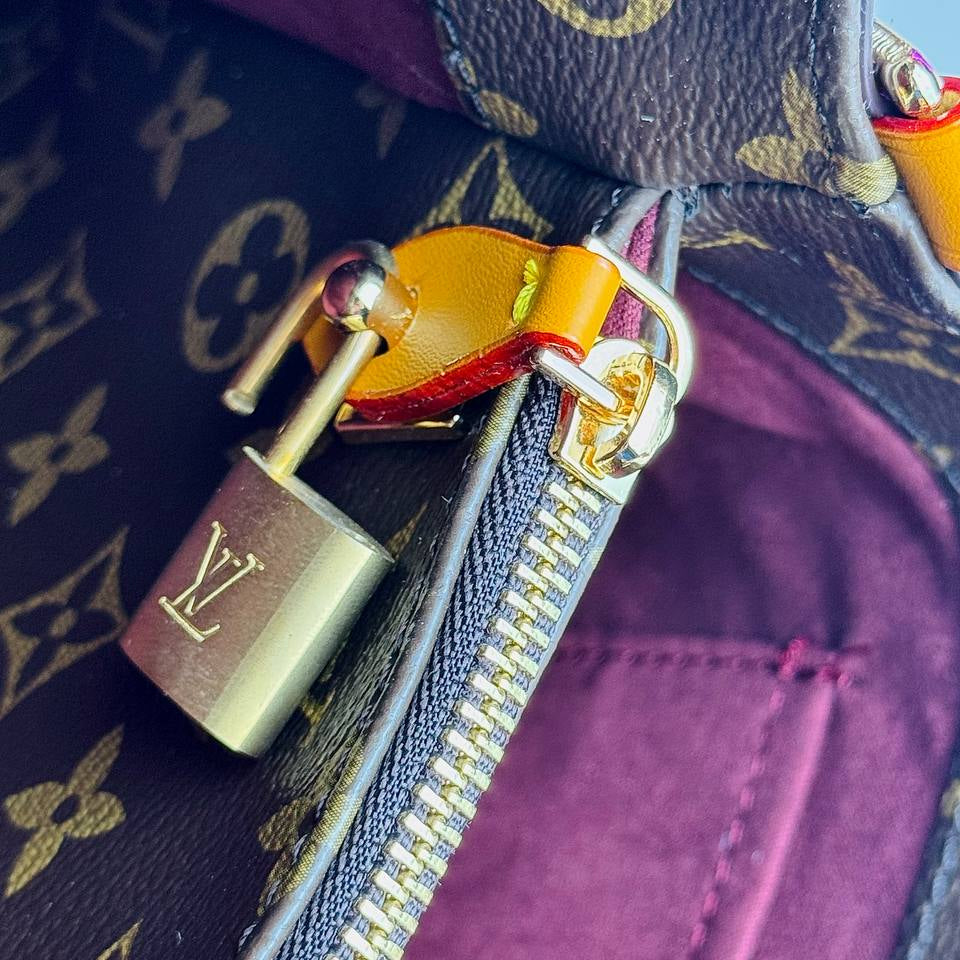 Louis Vuitton Monogram Handbag with Vibrant Orange Accents