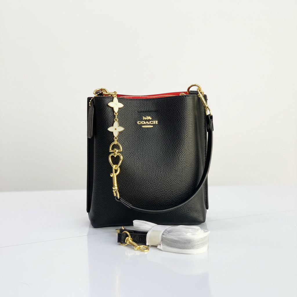 Coach Black Shoulder Bag with Gold-Tone Hardware and Charm