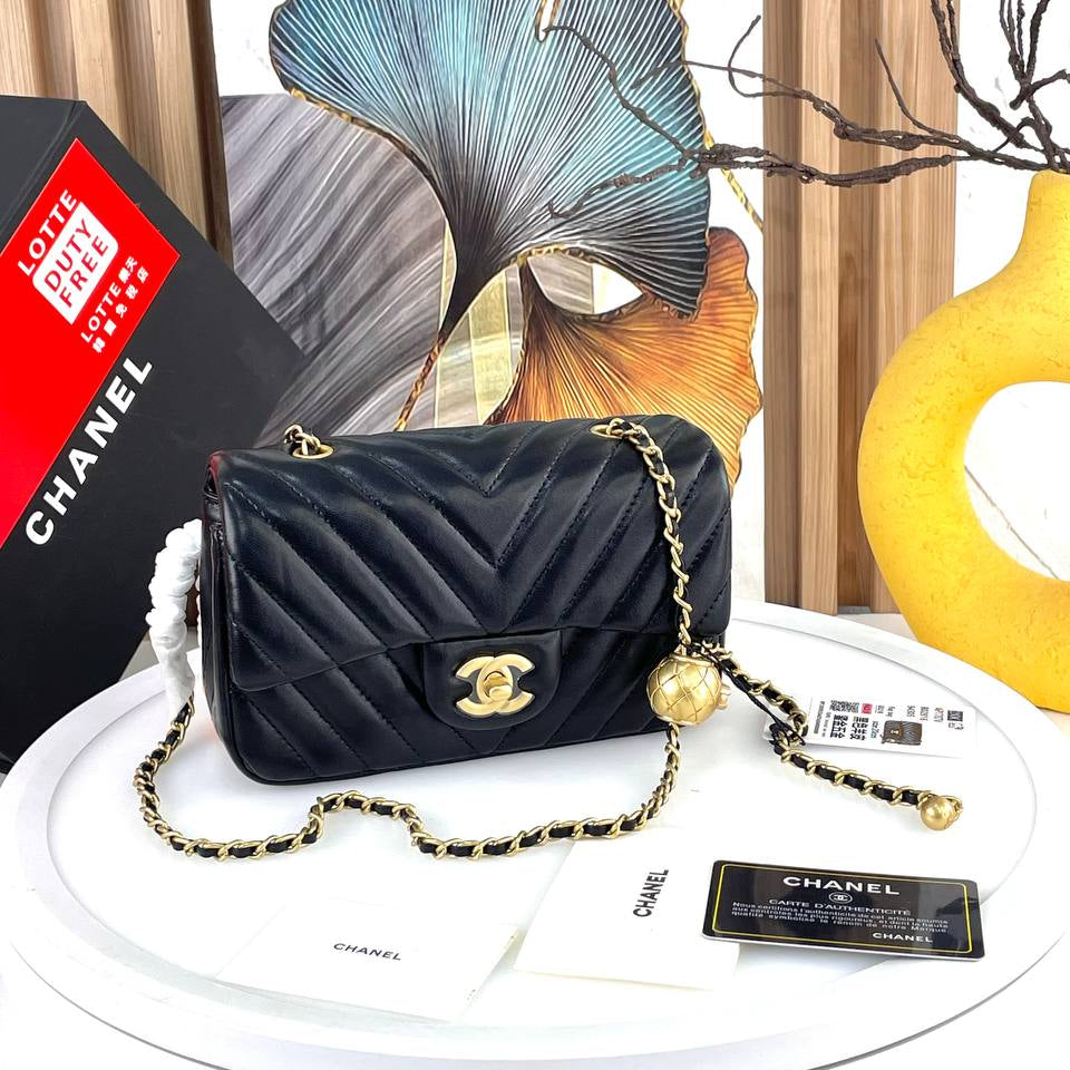Chanel Black Leather Flap Bag with Signature Gold Ball Detail