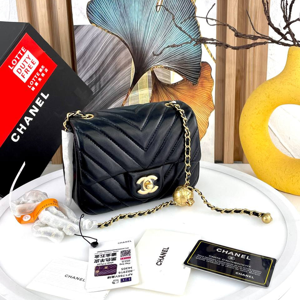 Chanel Black Leather Flap Bag with Signature Gold Ball Detail