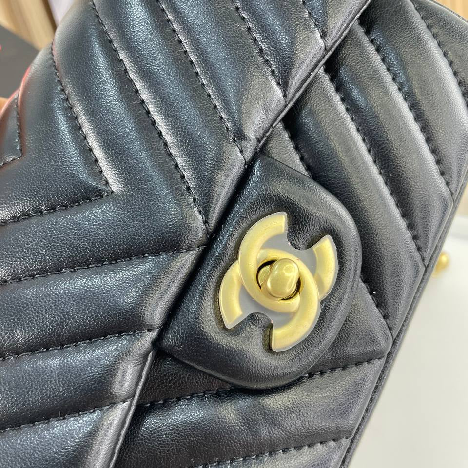 Chanel Black Leather Flap Bag with Signature Gold Ball Detail