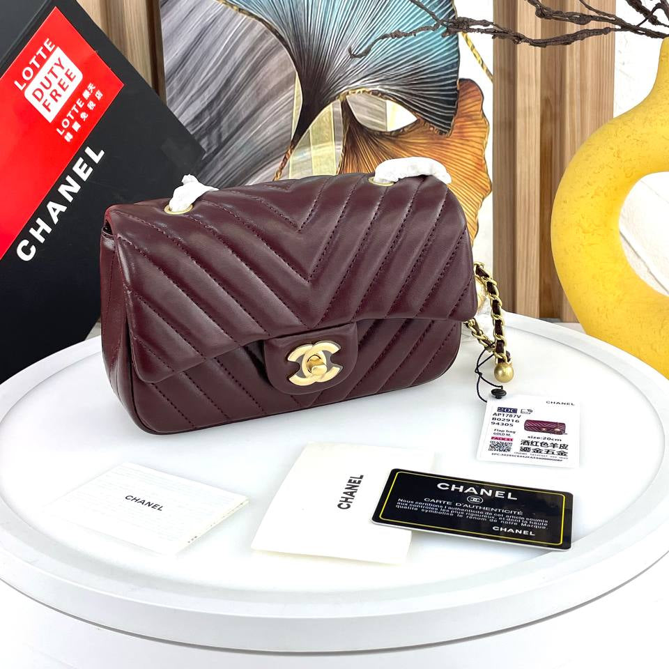 Chanel Black Leather Flap Bag with Signature Gold Ball Detail