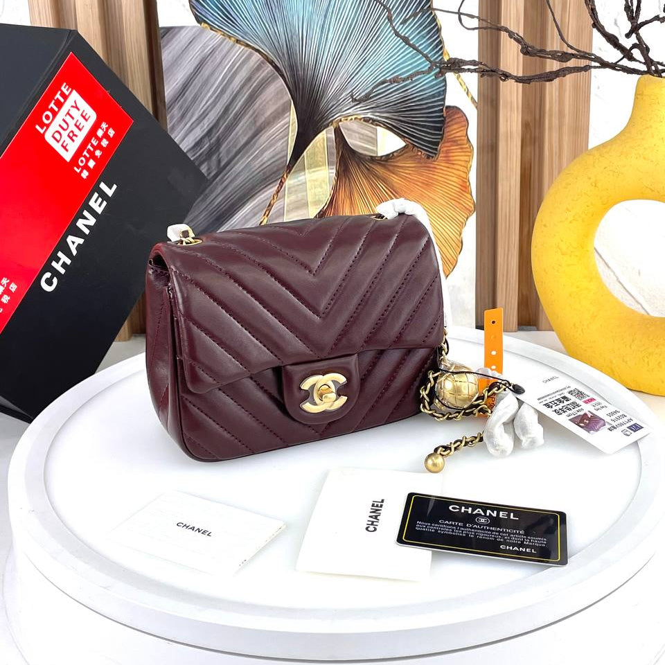 Chanel Black Leather Flap Bag with Signature Gold Ball Detail